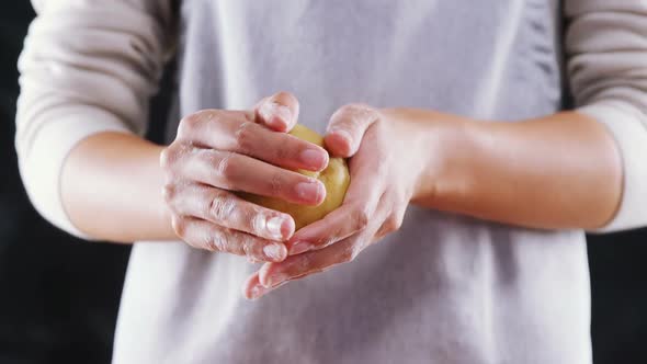 Woman molding a dough ball alt