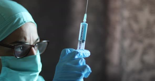 Doctor holding a syringe with the coronavirus COVID-19 vaccine