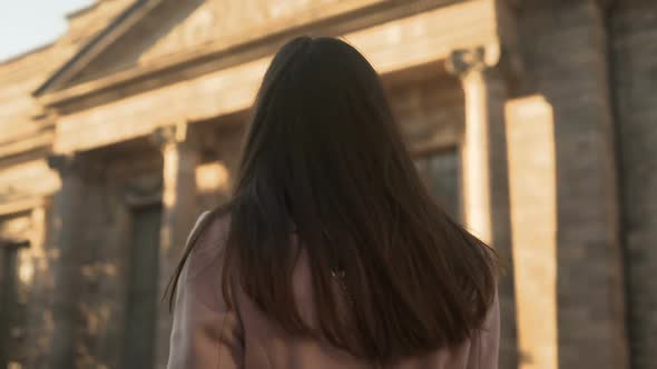 Attractive Young Woman Turning to Camera, Standing Near University Campus alt