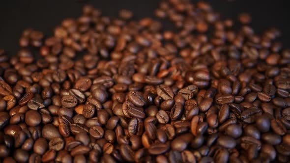 Roasted coffee beans on a black background. Coffee closeup.