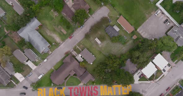 Bird eye view of a large "Black Towns Matter" sign painted on street in Houston Historical independe alt