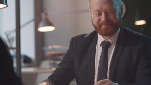 Businessman Giving Handshake and Discussing Contract with Colleague alt