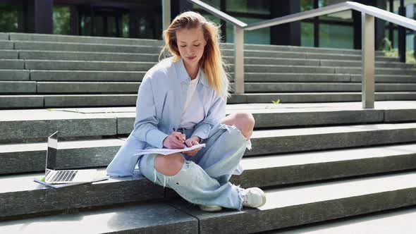 Pretty Girl Student Writing Notebook Elearning Sitting on Stairs Outside Campus alt