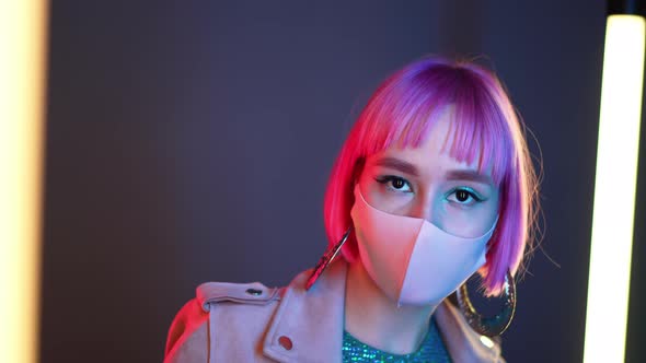 Young Beautiful Fashionable Woman in Protective Mask Dancing in Night Club alt