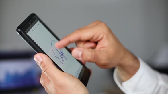Man Signing Contract on Smartphone with Electronic Signature