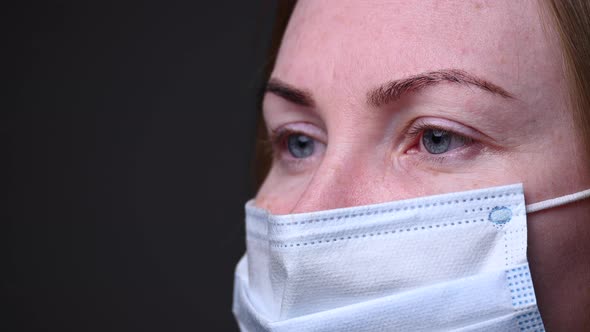 A Masked Girl Reads the Information. Eyes Move. Epidemic Covid-19 in China. Viruses and the Pandemic alt