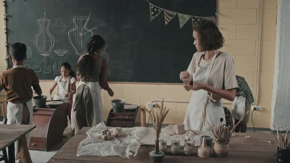 Kids and Teacher in Pottery School alt