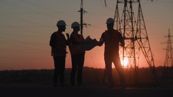 Development of Electrical Structure in City Professional Engineers in Helmets are Discussing alt
