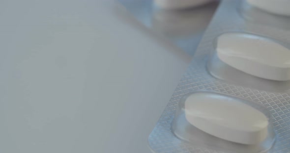 Prescription drugs - Capsules, pills, tablets on reflective background alt