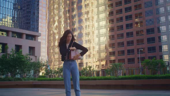 Woman Taking Picture Buildings Getting Phone From Bag alt