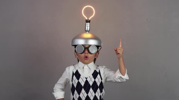 Funny child wearing handmade helmet with lightbulb. Slow motion alt