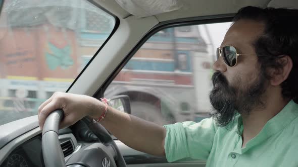 Indian Man with Googles and Bear Talking Driving Car