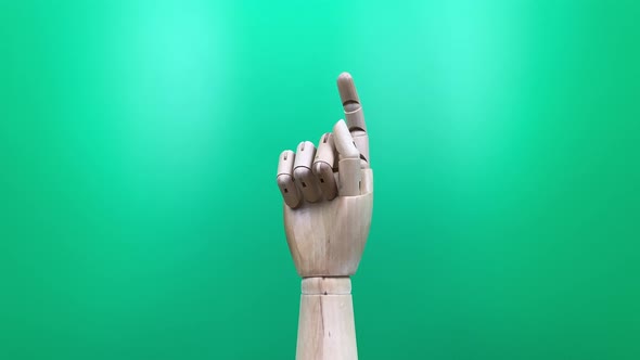 Wooden hand on green background