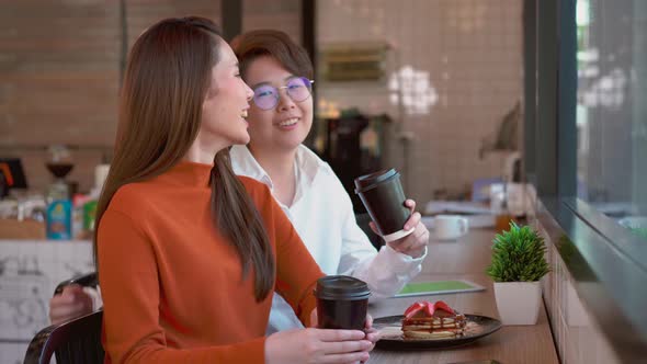 Attractive gay women talking and laughing and show affection for each other, Lesbians hug on a date. alt