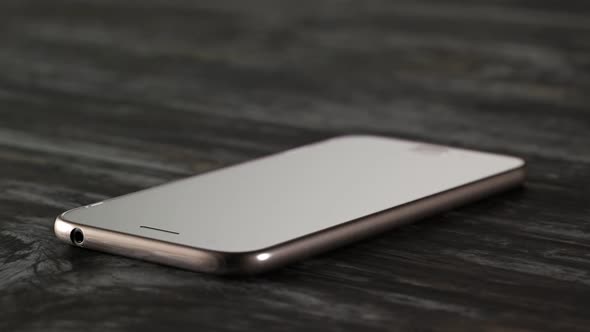 Hammer smashes smartphone in slow motion. Angry destroying mobile technology. alt