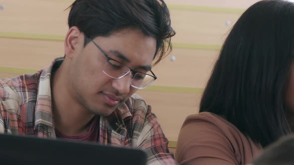 Indian Guy and Afro-american Girl Sitting at Lecture Hall alt