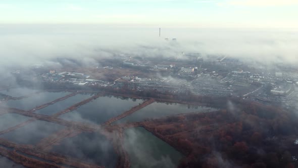 Aerial Drone View Flight Over Above Fog Mist and Roofs of Buildings in City alt