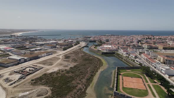 Aerial flight along Peniche old city wall and moat, panoramic view