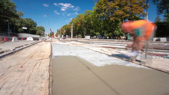Concrete Works for Road Construction with Workers and Mixer Timelapse alt