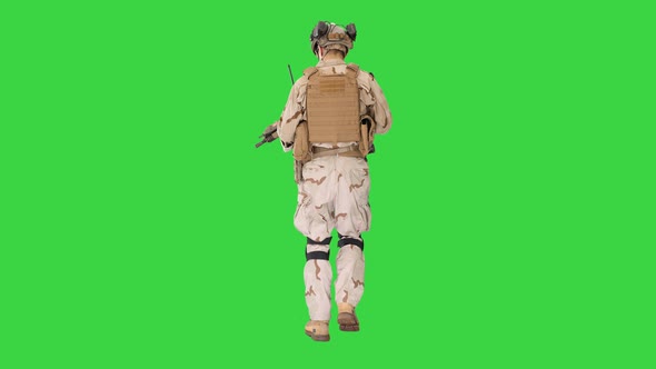 US Army Ranger in Combat Uniform Walking on a Green Screen, Chroma Key. alt