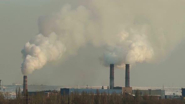 Three industrial chimneys smoke. Air pollution concept.