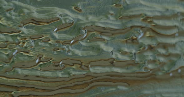 Macro shot of acrylic glass with abstract figures on it. Camera tilts up. alt