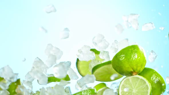 Super Slow Motion Shot of Flying Fresh Lime Slices and Crushed Ice on Background at 1000 Fps alt
