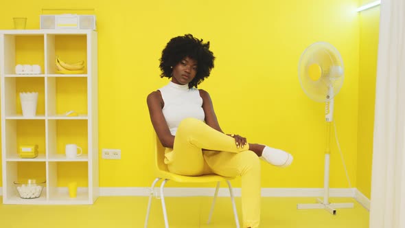 Portrait of African Woman Sitting In Yellow Office alt
