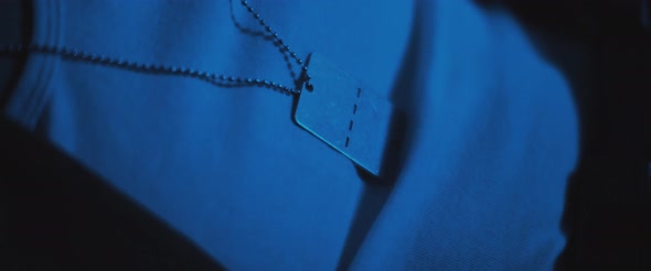 Close up of a soldier in uniform, sitting in a room, dealing with PTSD. alt