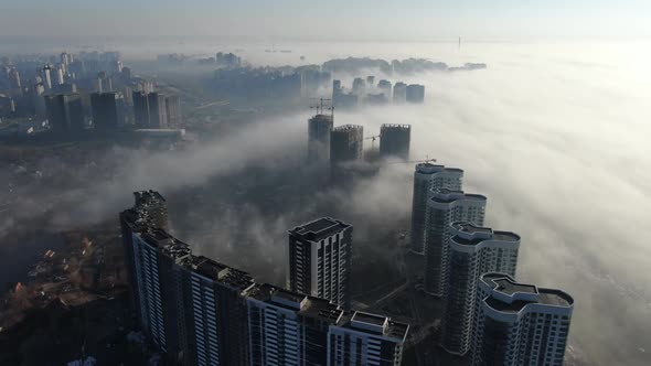 Flying Under City In Fog