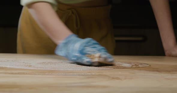 Process of Cleaning the Wooden Countertop of the Kitchen Table