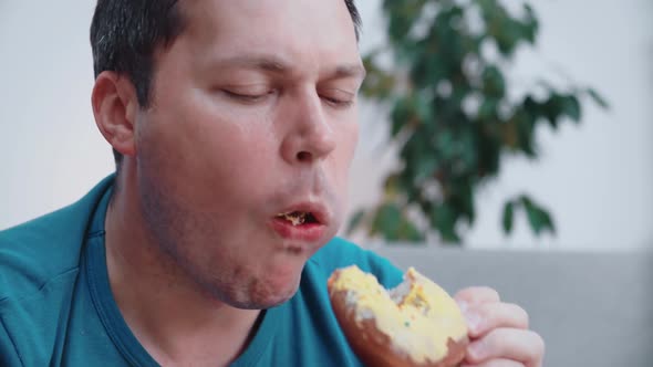 Close-up of a man eating a donut
