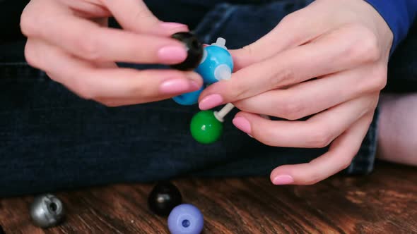  Woman's Hands Building Molecule Models of Colored Plastic Construction Set.