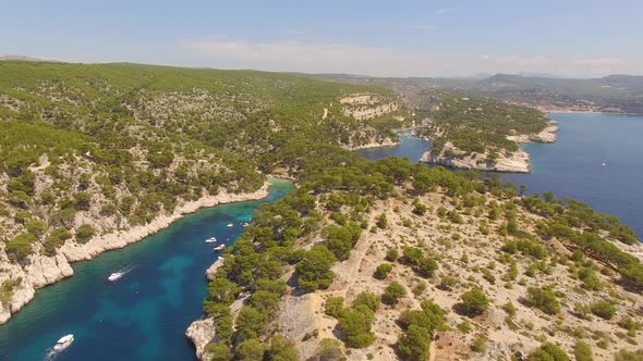 Aerial travel drone view of clear green water, cliffs of Cassis, Mediterranean Sea, Southern France. alt