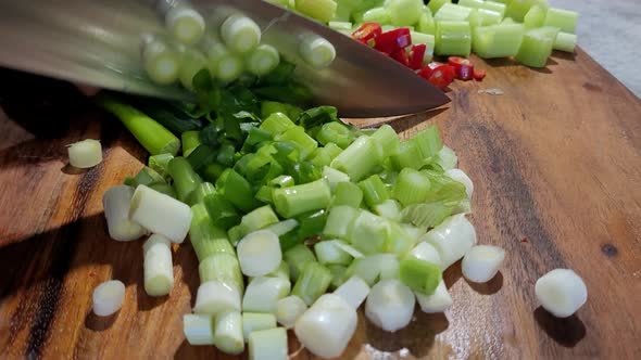 Chopping vegetables on a wooden board.