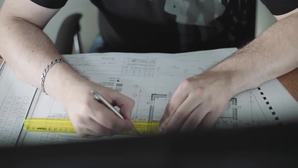 An Engineer Checks the Construction Drawings