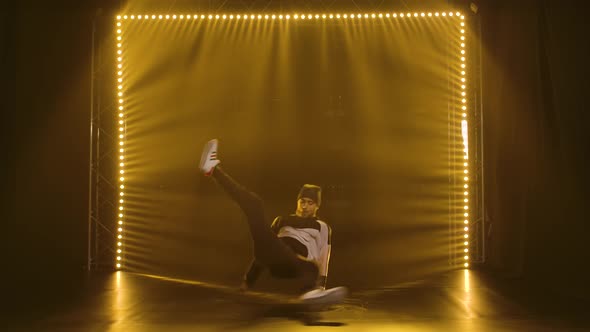Guy Dancing Break Dance. Hip Hop Street Dance on a Stage with Smoke and Neon Lights. Slow Motion. alt