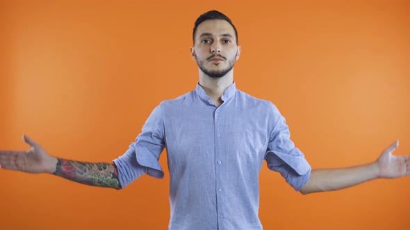 Young Man in Casual Clothes Standing with Closed Eyes in Praying Gesture. Wish for Something To alt