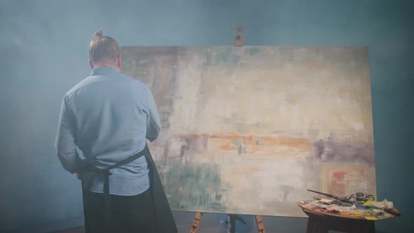 Artist's Workshop Creative Person at Work a Talented Adult Man Artist Covers the Canvas with Beige alt