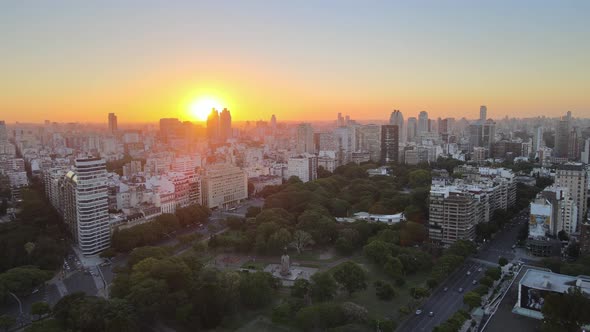 Dolly in flying above Recoleta neighborhood squares and buildings in background at golden hour, Buen alt