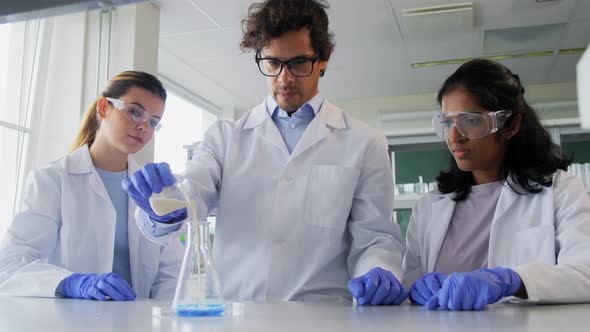 Scientists with Chemicals Working in Laboratory