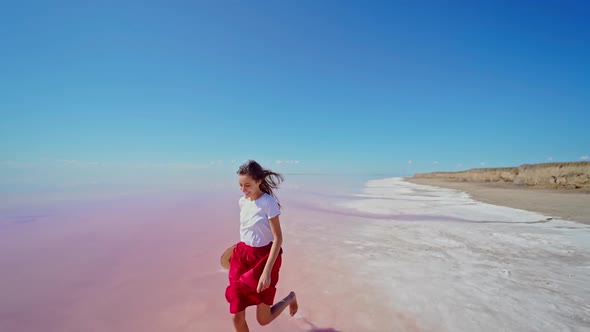 Running Woman By Infinite Horizon Empty Space at Pink Lake During Summer Travel alt