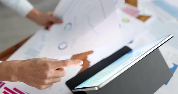 Businesswoman Using Digital Tablet Reviewing Financial Statement Report alt