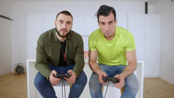 Point of View From TV of Two Absorbed Men Playing Video Game Using Game Consoles alt