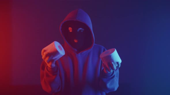a thief in a mask with toilet paper in his hands