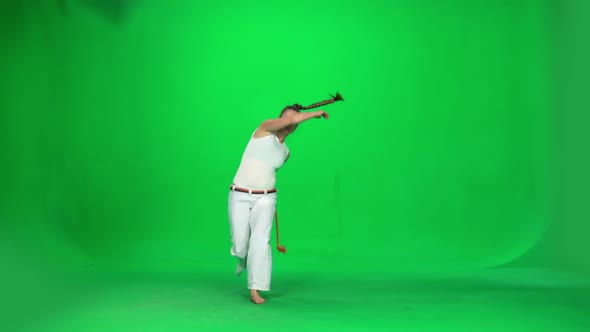 Woman with Long Hair Practicing Capoeira on Chroma Key Studio. Slow Motion. alt