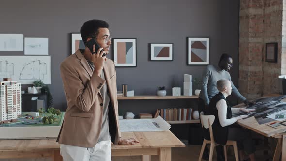 Young Businessman Talking on Phone alt