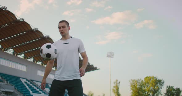 Tilt Up with Slow Motion of Male From Professional Soccer League Juggling Ball on Leg in Outdoor alt