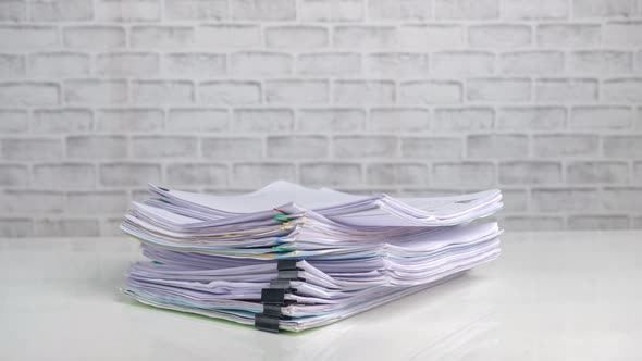 Stop motion animation, Stacks of business paper files on office desk,