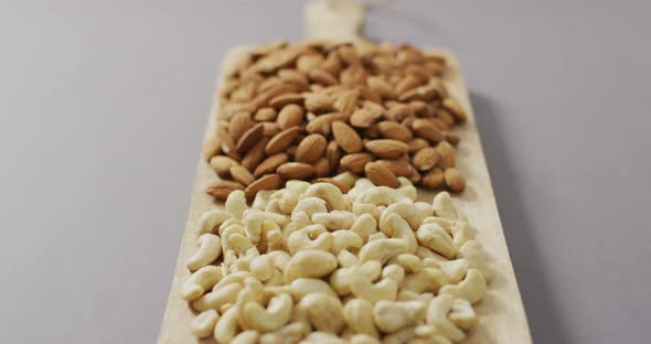 Video of almonds on wooden chopping board alt